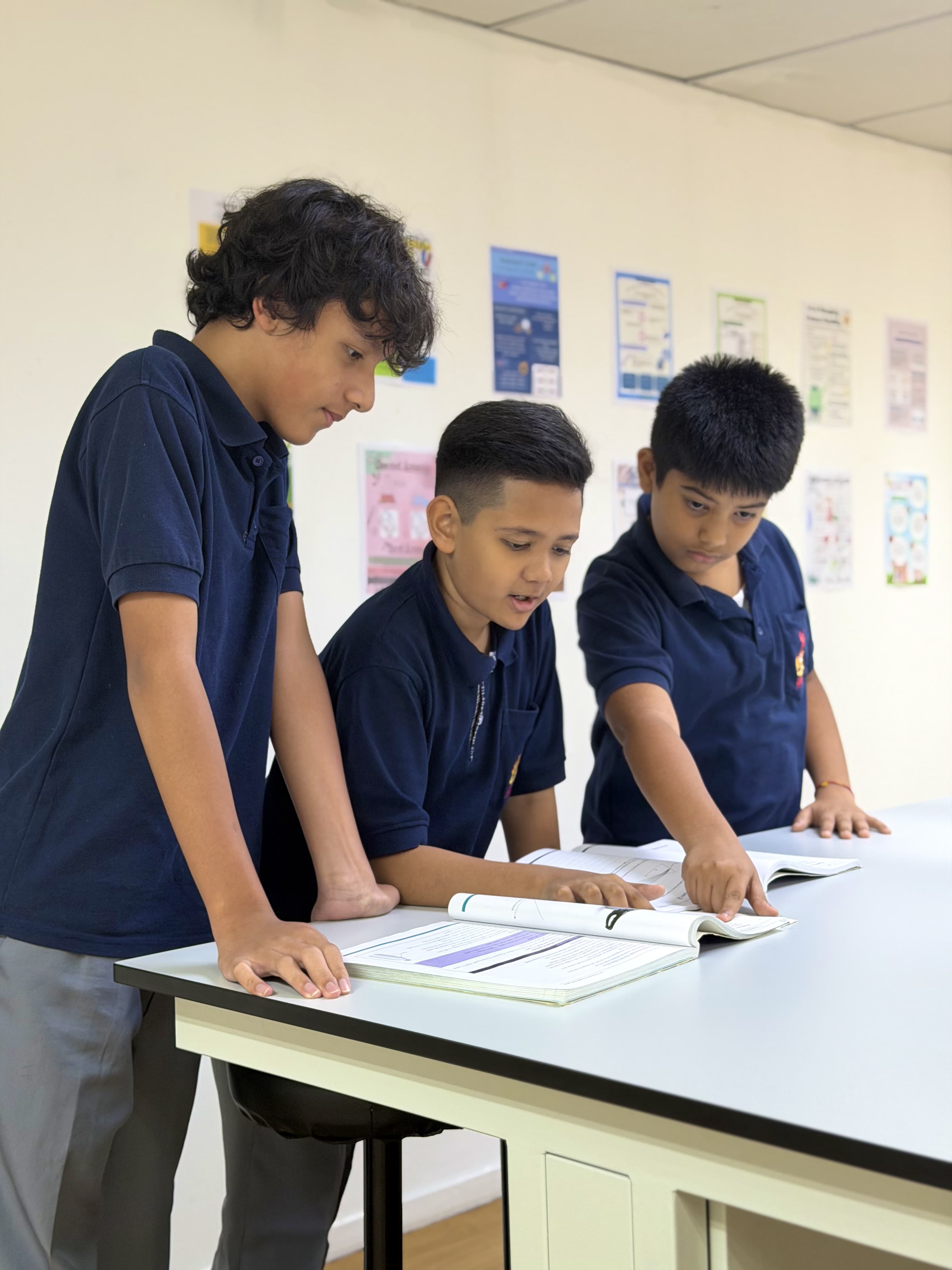 Students learning together through an engaging classroom experience at Qosmo.